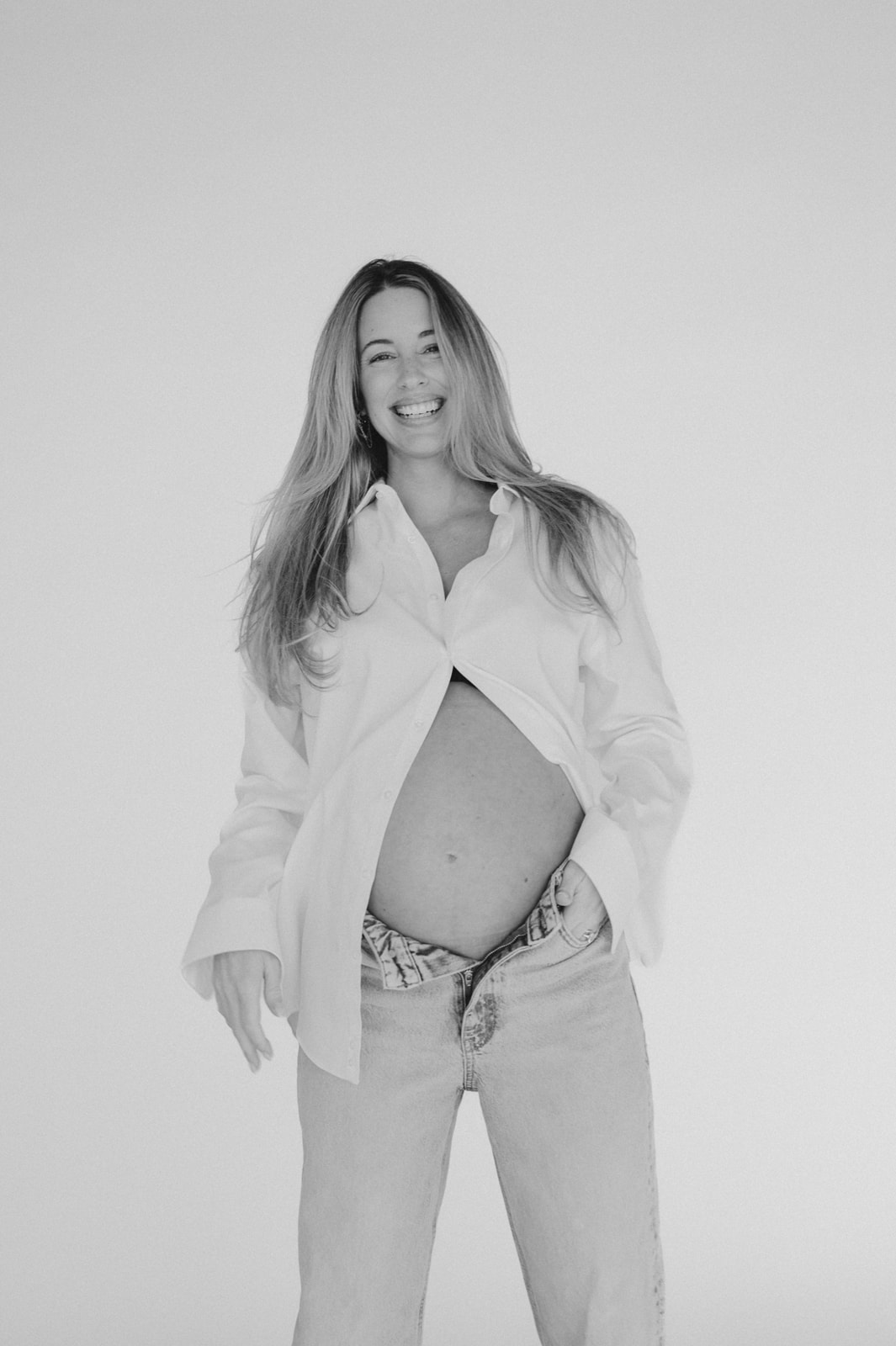 black and white maternity session on white backdrop in studio