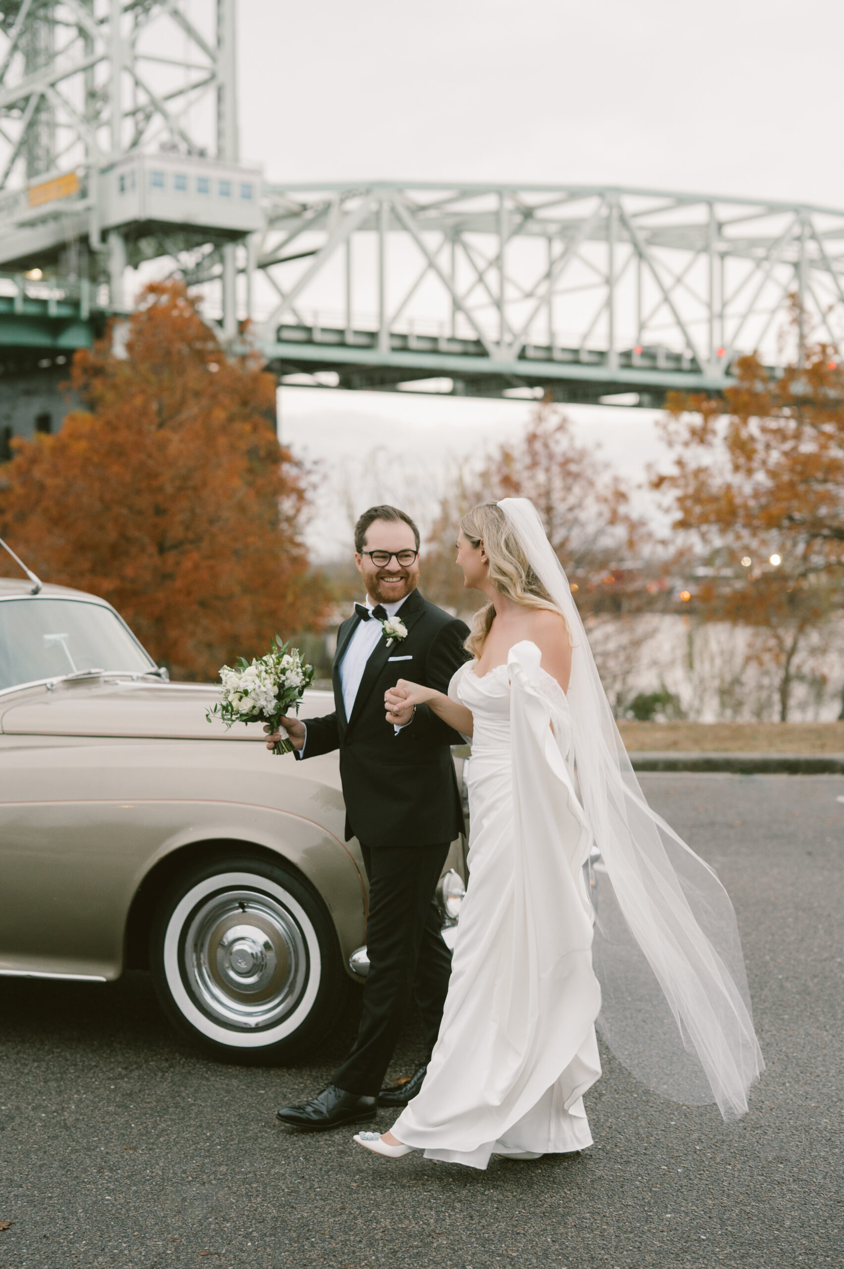 Newlywed Couple in downtown wilmington in front of a classic car